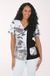 Woman wearing a black and white patterned top on a white background