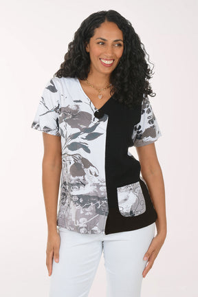 Woman wearing a black and white patterned top on a white background