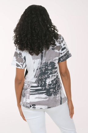 Woman wearing a black and white patterned top on a white background