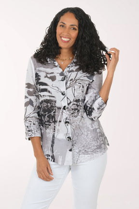Woman wearing a patterned shirt and white pants on a white background