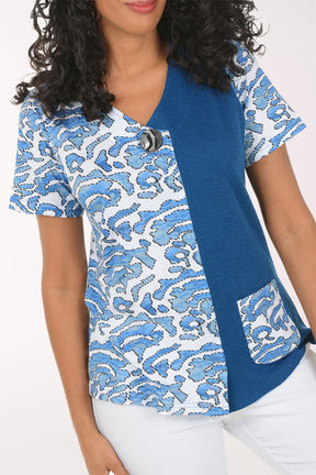Woman wearing a blue and white patterned blouse top on a white background