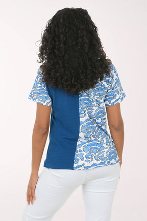 Woman wearing a blue and white patterned blouse top on a white background