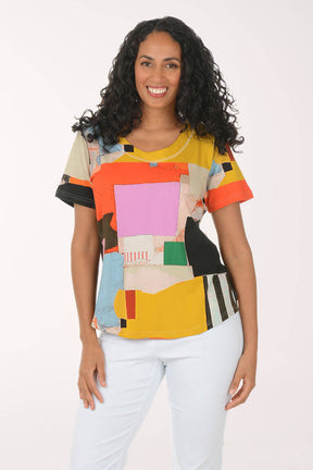 Woman wearing a colorful geometric-patterned shirt on a white background
