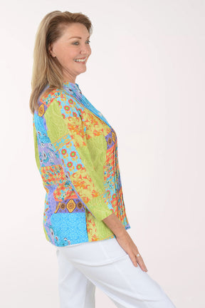 Woman wearing a colorful patterned blouse on a white background