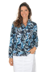 Woman wearing a blue and black leaf-patterned jacket on a white background.