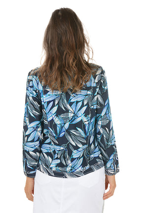 Woman wearing a blue and black leaf-patterned jacket on a white background. Back shot.