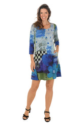 Woman wearing a colorful dress with abstract patterns on a white background.