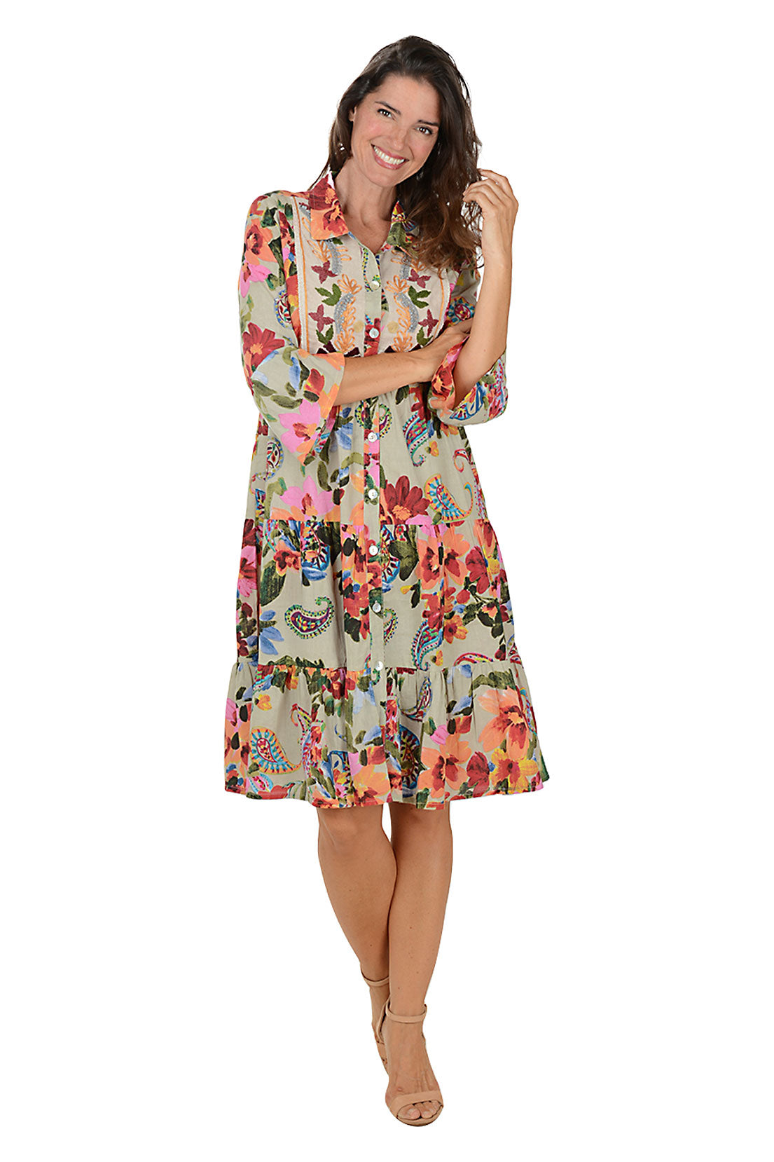 Woman wearing a 3/4 sleeve collared floral dress on a white background.