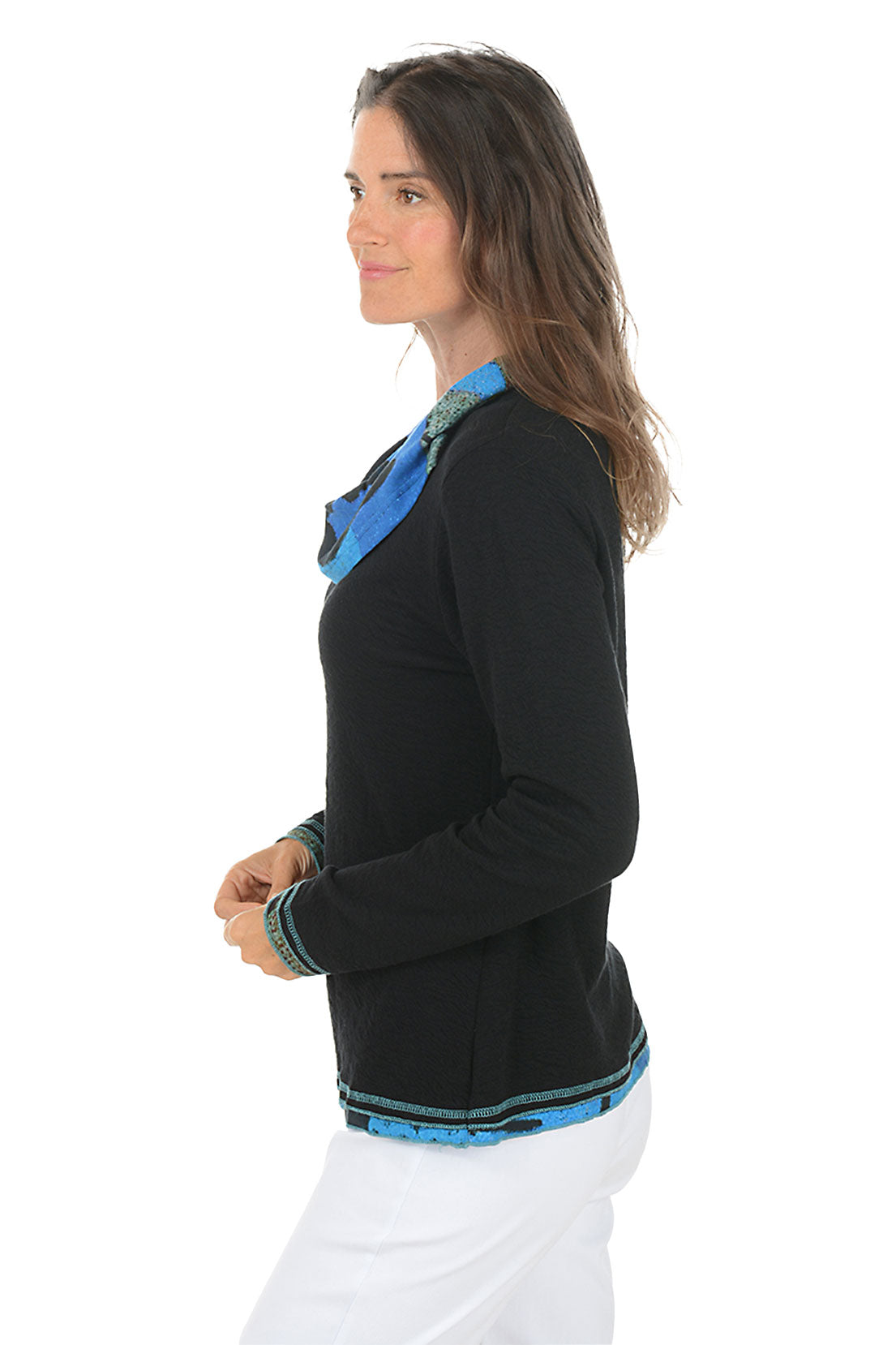 Woman wearing a black sweater with blue colorful trim on a white background. Side shot.