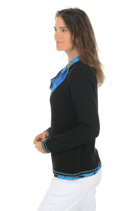 Woman wearing a black sweater with blue colorful trim on a white background. Side shot.