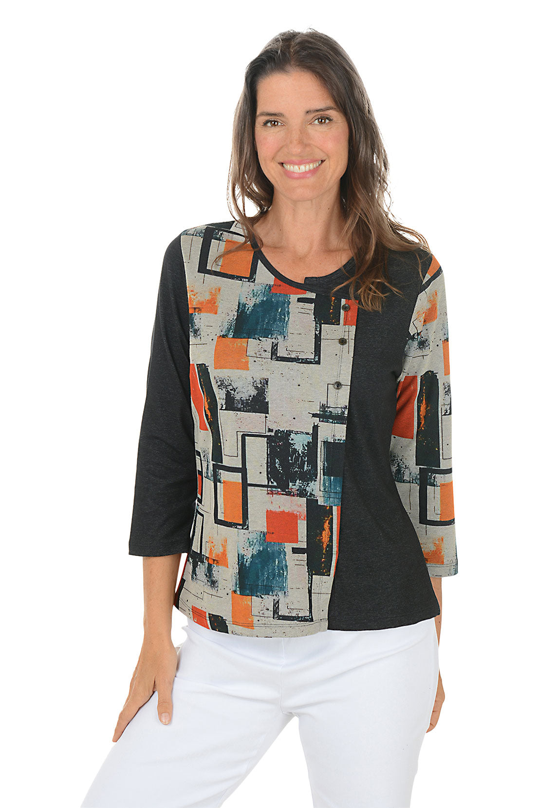 Woman wearing a 3/4 sleeve black and multicolor abstract patterned top with white pants on a white background.