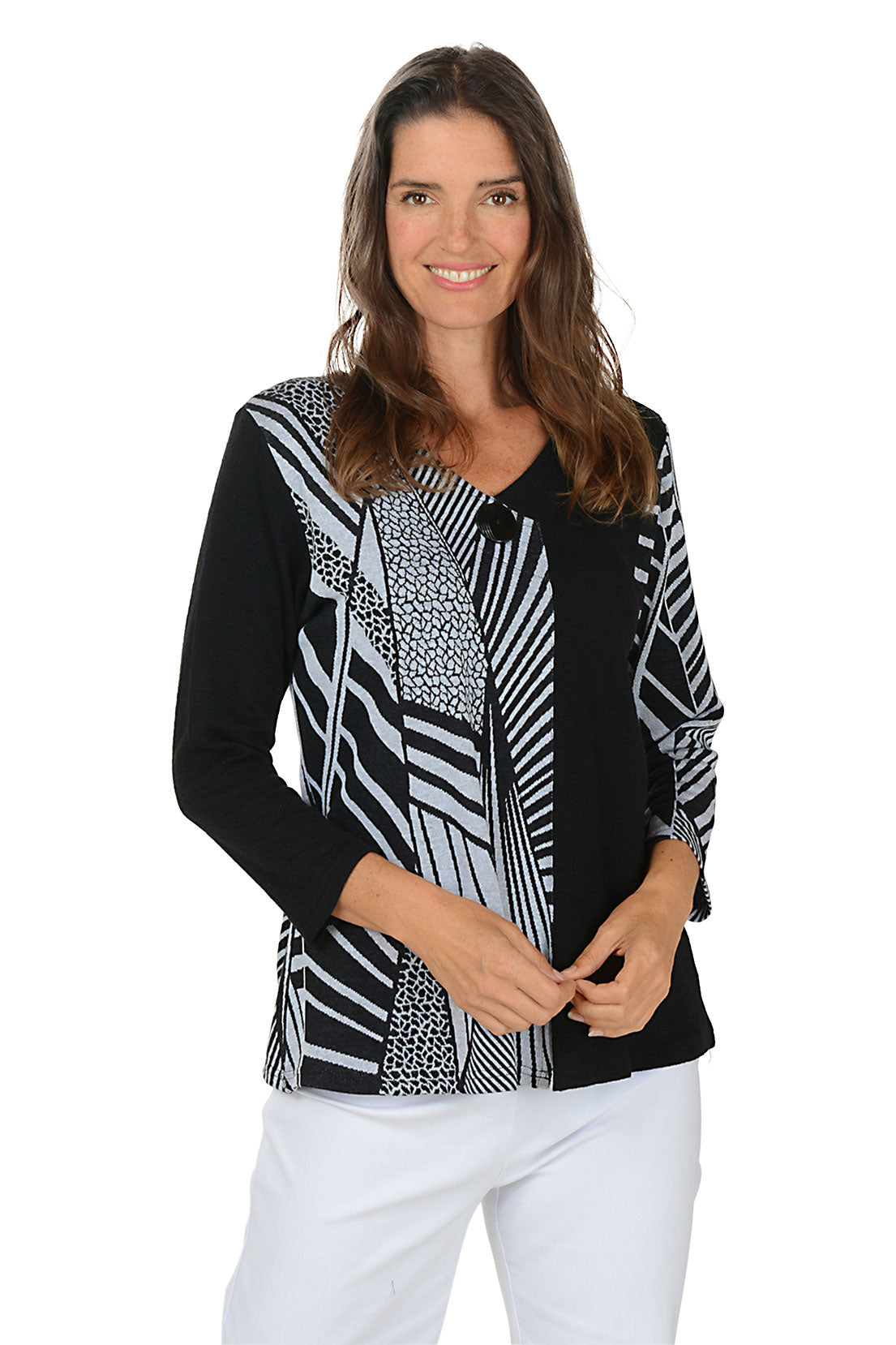 Woman wearing a black and white patterned blouse with a white background.