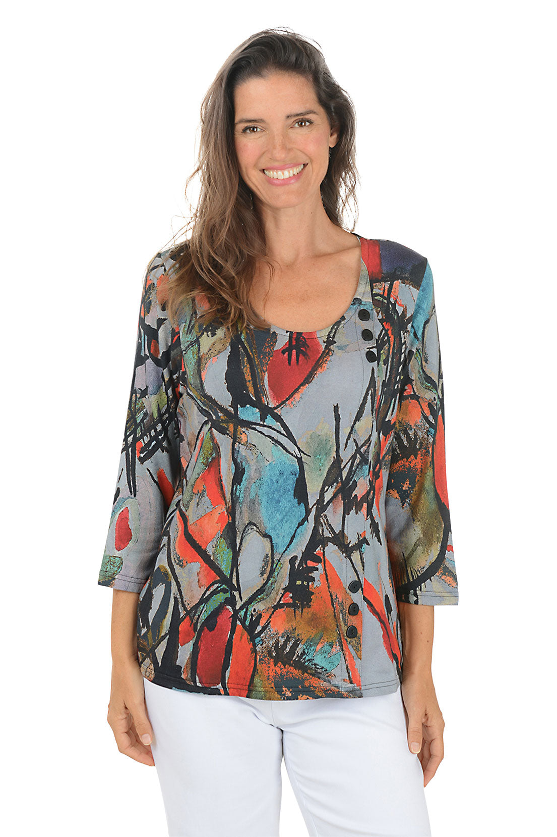 Woman wearing a 3/4 sleeve colorful abstract patterned top on a white background.