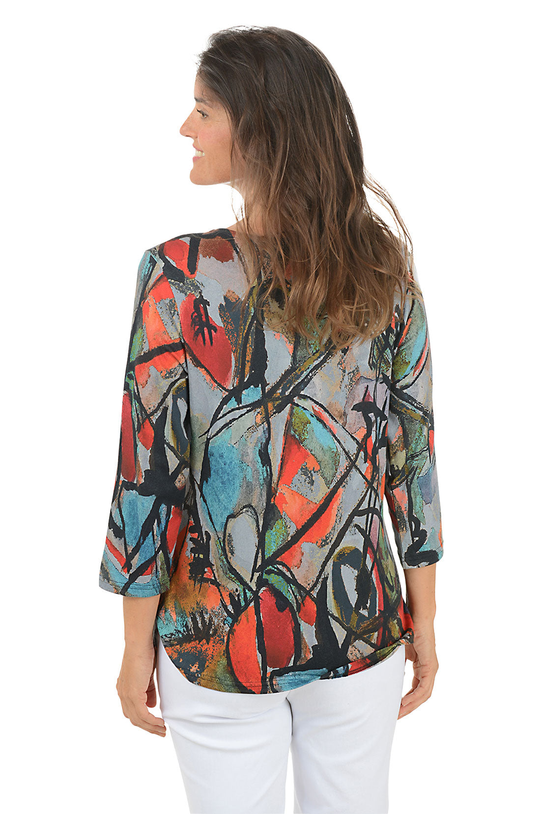 Woman wearing a 3/4 sleeve colorful abstract patterned top on a white background. Back shot.