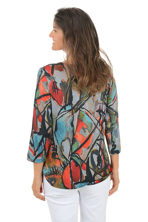 Woman wearing a 3/4 sleeve colorful abstract patterned top on a white background. Back shot.