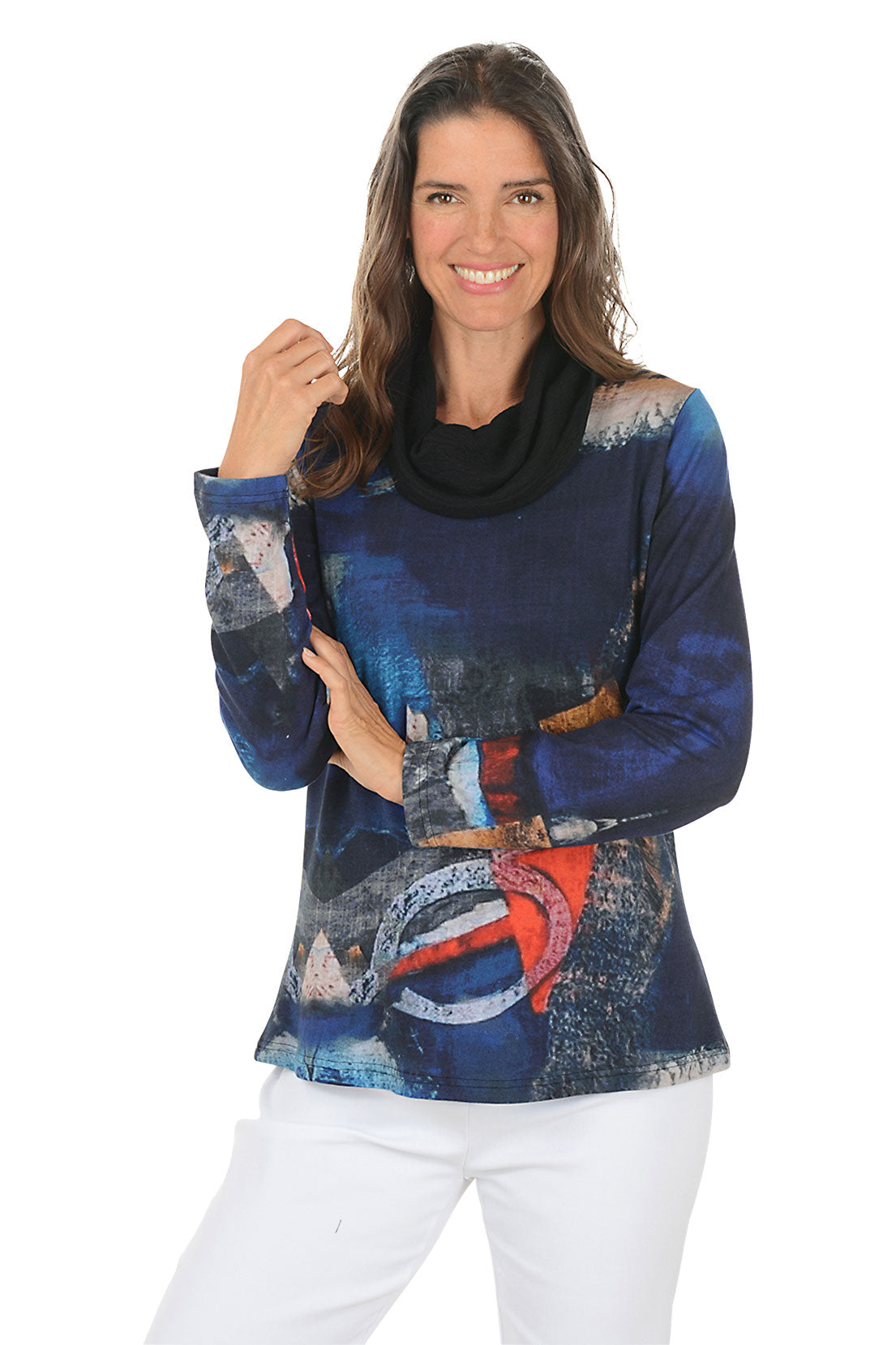 Woman wearing a colorful long-sleeve top with abstract design on a white background.