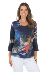 Woman wearing a 3/4 sleeve colorful abstract patterned top on a white background.