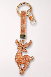 A champagne and rose gold rhinestone reindeer bag charm on a matching rhinestone strap with a gold clasp.