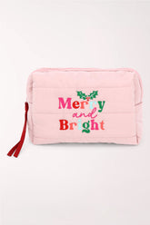 A light pink quilted cosmetics pouch with "Merry and Bright" embroidered in red and pink with holly leaves, and a red zipper pull.