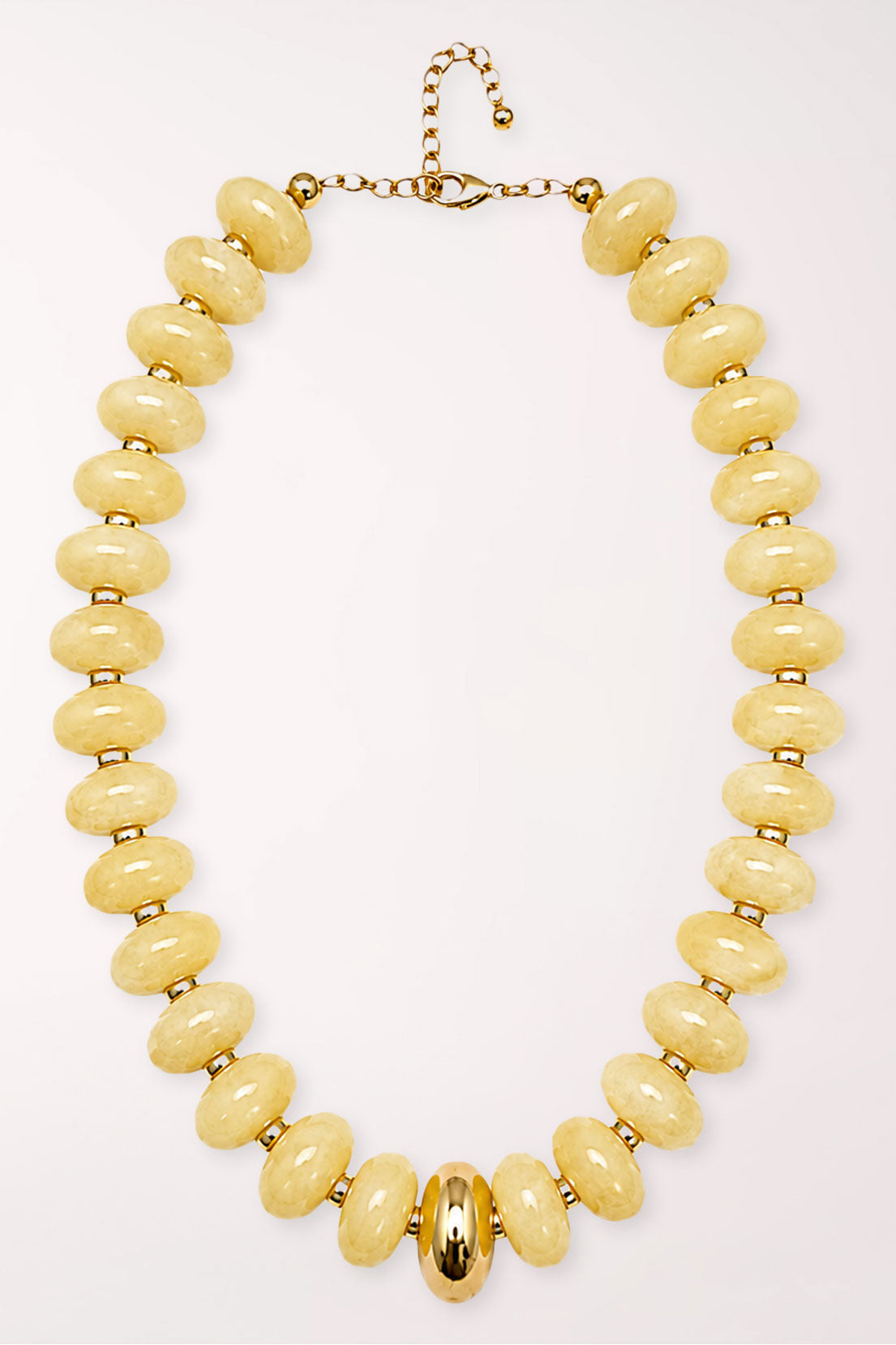 Gold Accent Marble Bead Necklace in Butter, laid flat: a strand of large rounded pale butter-yellow marbled beads with small gold spacers, a polished gold oval bead at center front, and a gold lobster clasp with extender chain.