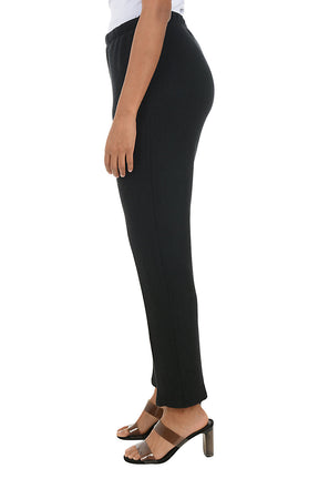 Black fleece lounge pants worn by a person on a white background. Side shot.