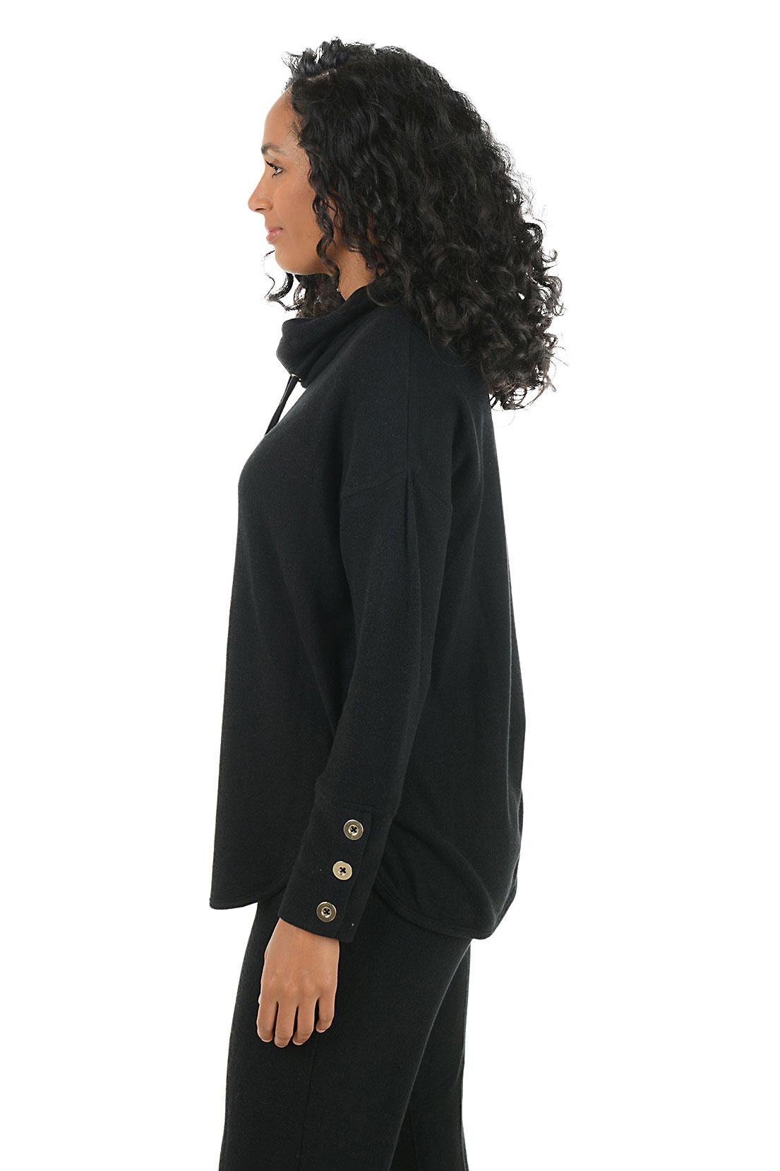 Woman wearing a black hoodie with button details on the arm on a white background. Side shot.