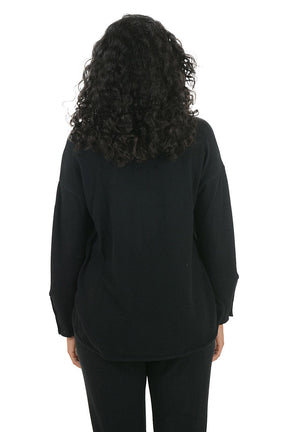 Woman wearing a black hoodie with button details on the arm on a white background. Back shot.