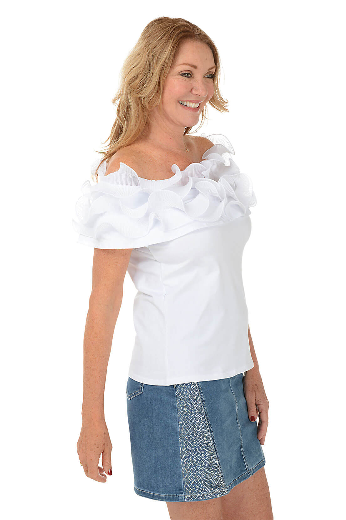 Woman wearing a white top with ruffles and a denim skirt on a white background