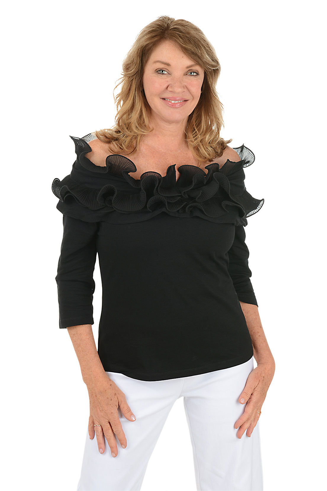 Woman wearing a black off-shoulder top with ruffles on a white background.