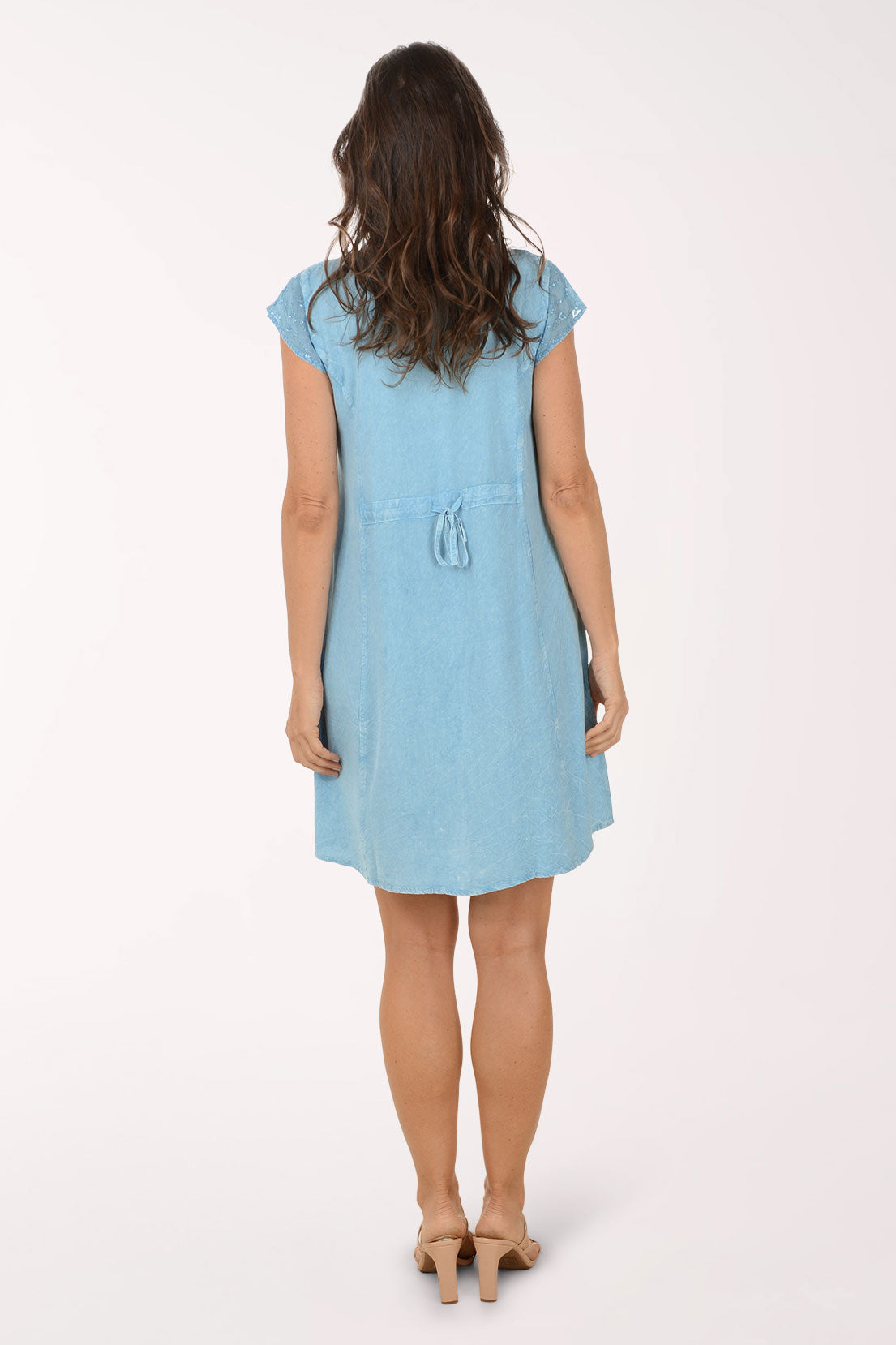 Woman wearing a light blue dress on a white background