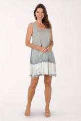 Woman wearing a gray and white tie-dye dress on a white background