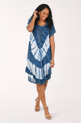 Woman wearing a blue and white tie-dye dress on a white background