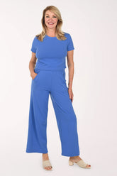 Woman wearing a two piece lounge set in blue