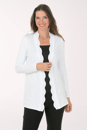 Woman wearing a white cardigan over a black top on a white background