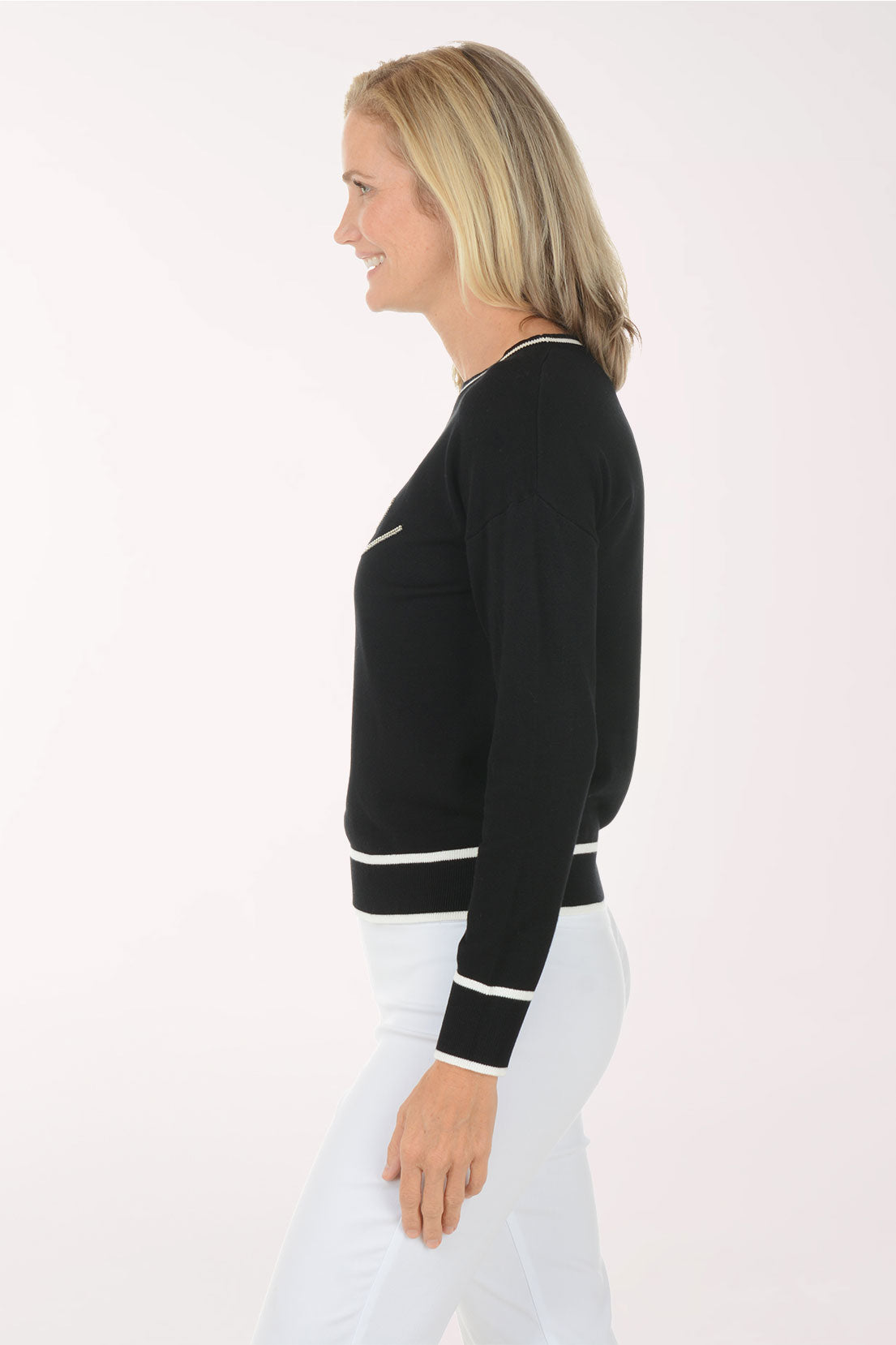 Woman wearing a black sweater with 'love' text on a white background