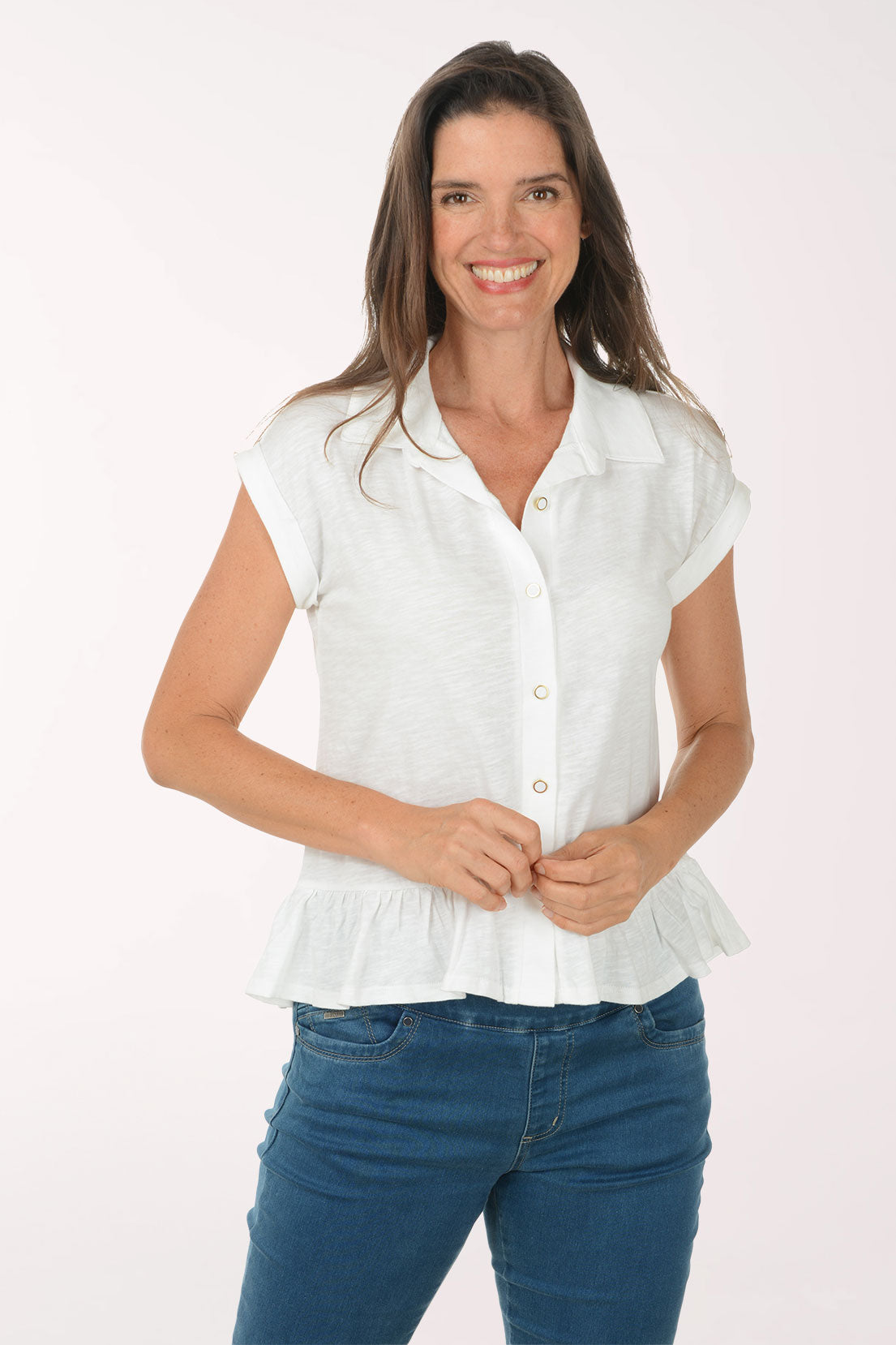Woman wearing a white blouse and blue jeans on a white background