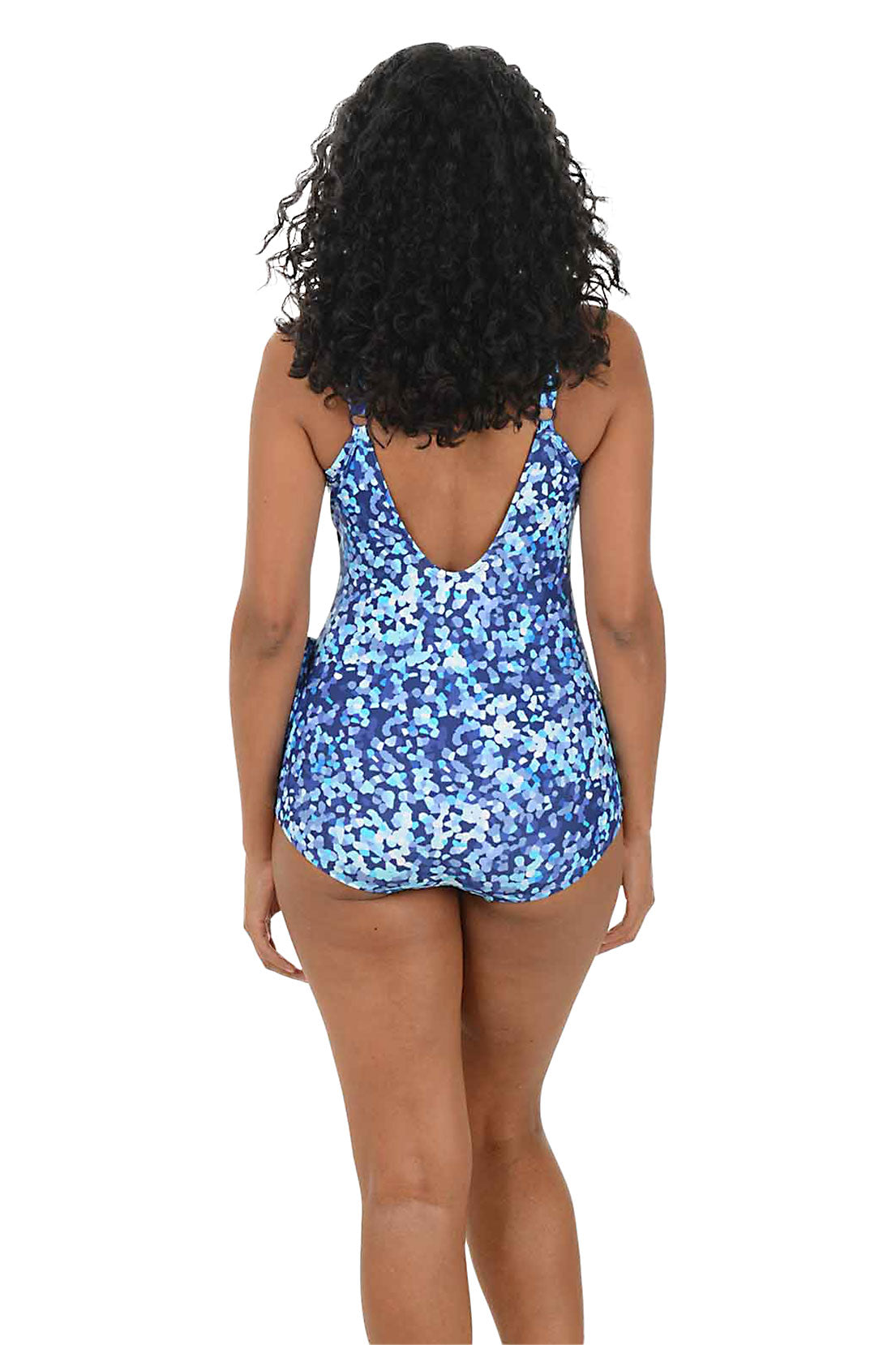 Woman wearing a blue floral swimsuit on a white background. Back shot.