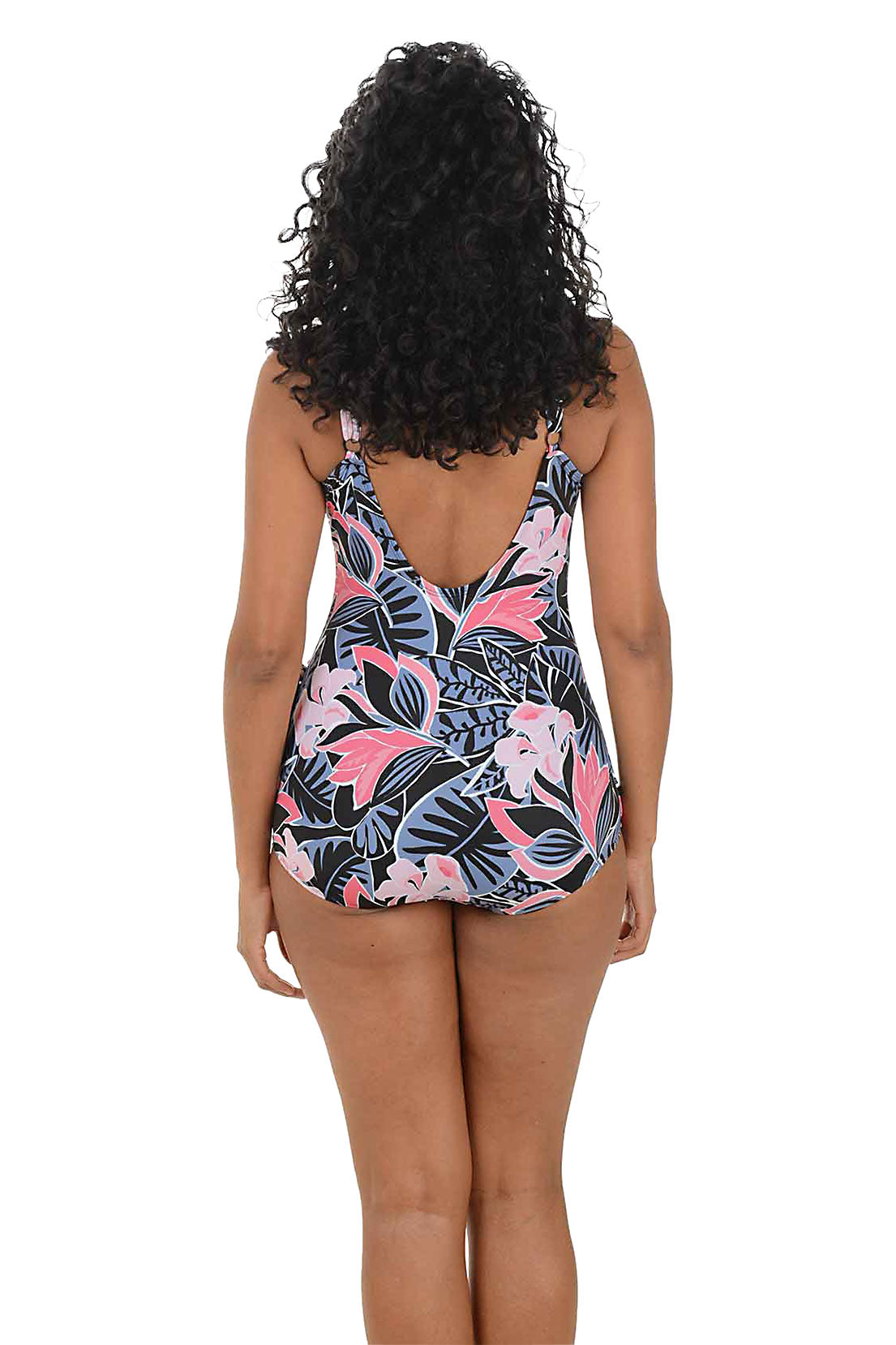 Woman wearing a floral swimsuit on a white background. Back shot.