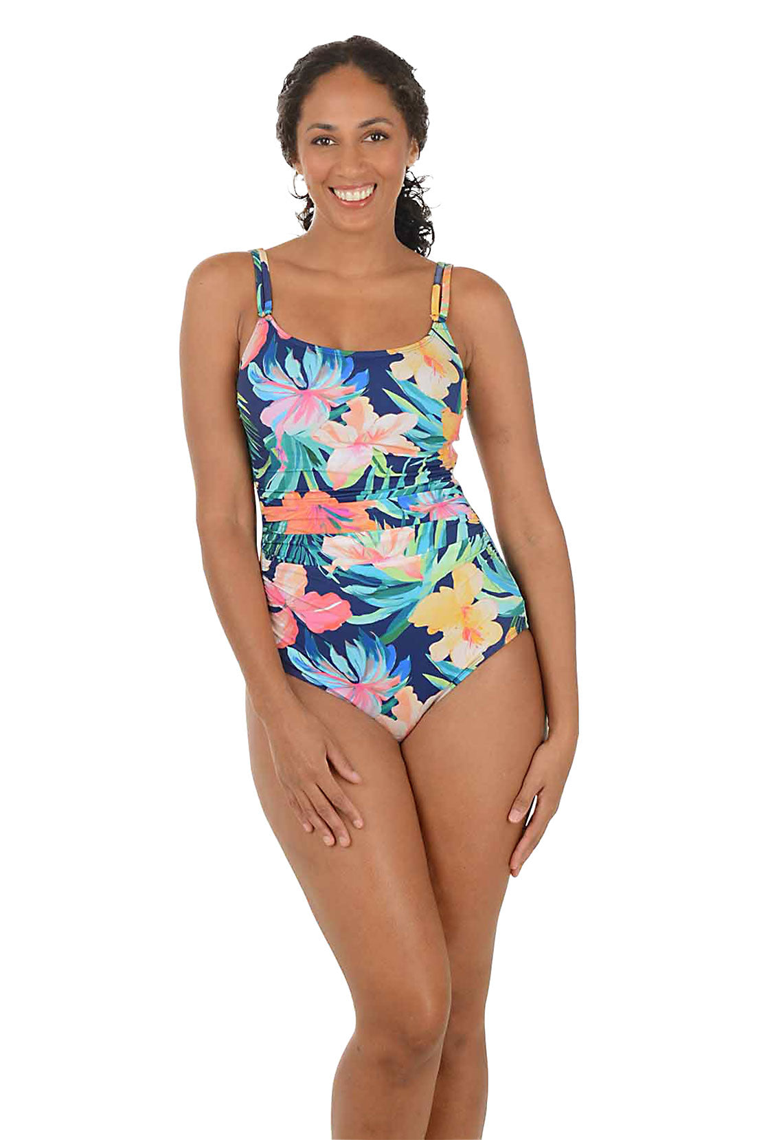 Woman wearing a colorful floral one-piece swimsuit on a white background.