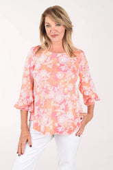 Woman wearing a floral blouse with a white background