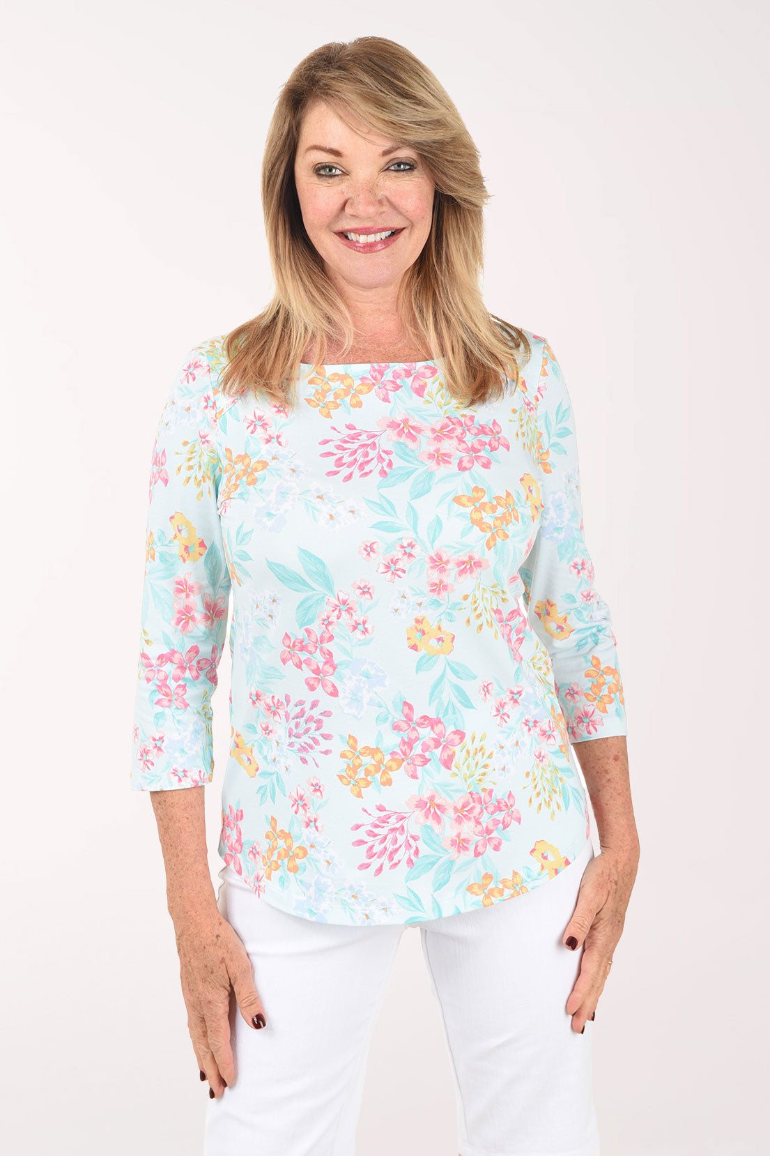 Woman wearing a floral print top on a white background