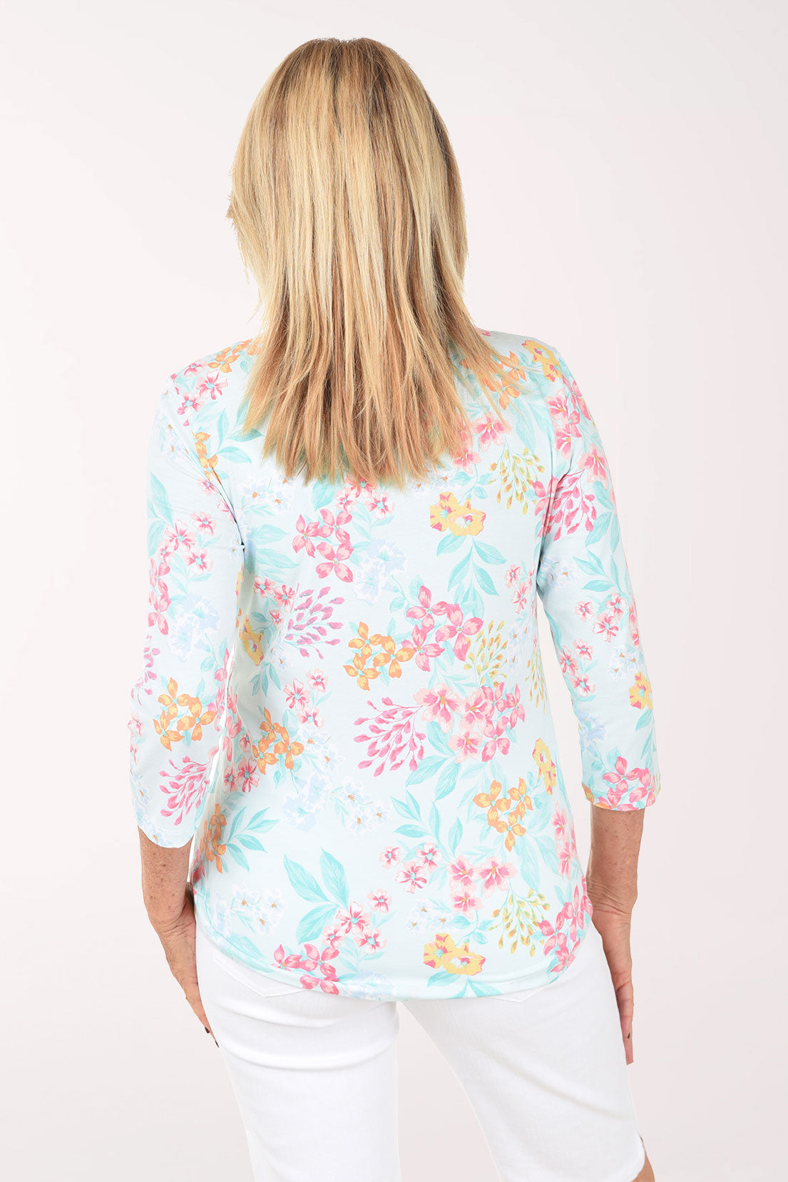 Woman wearing a floral print top on a white background