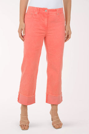 Coral pants worn by a person on a white background