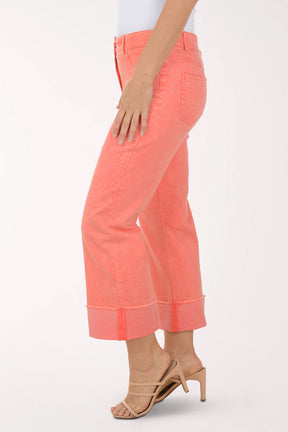 Coral pants worn by a person on a white background