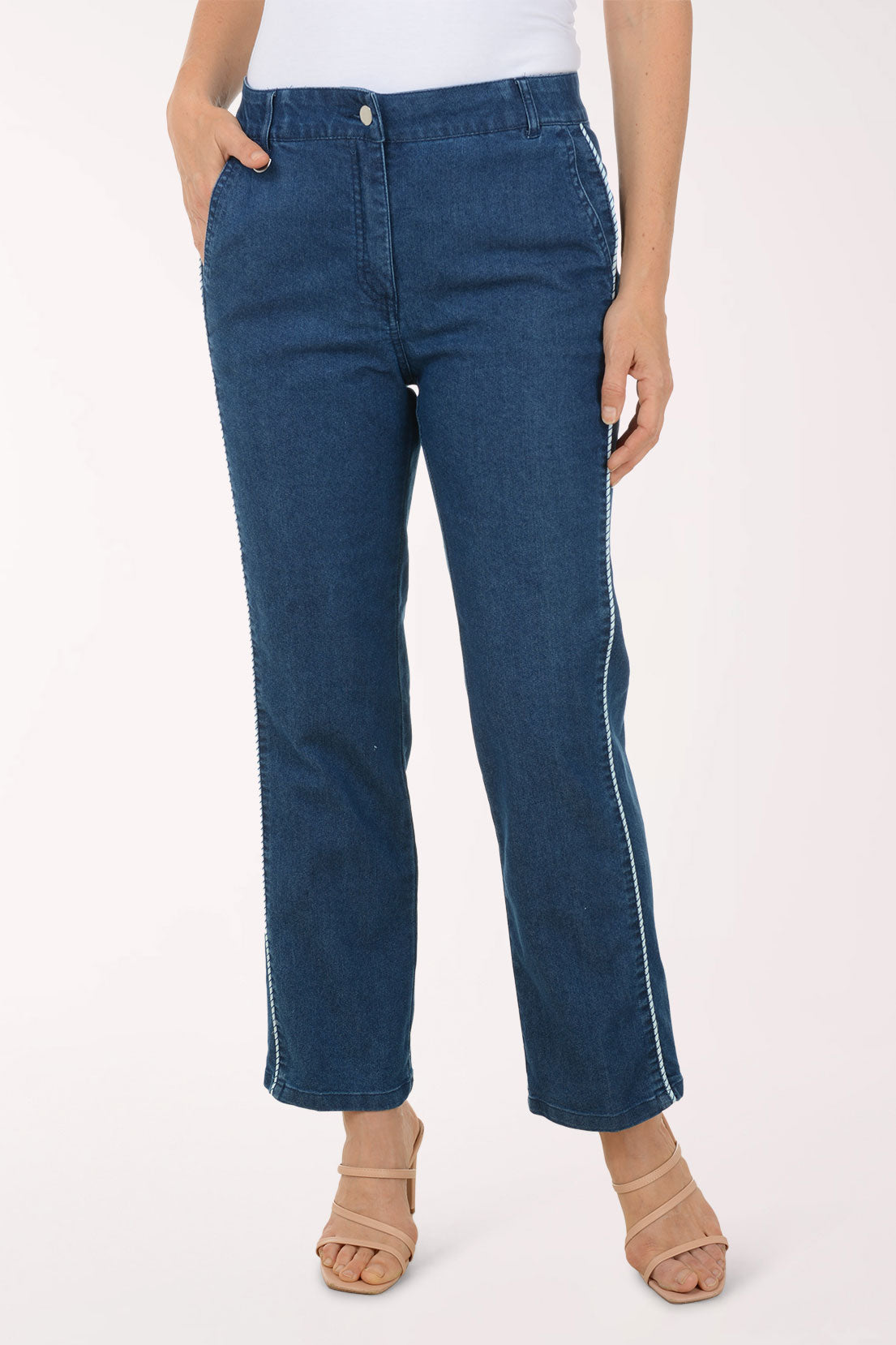 Person wearing blue jeans on a white background