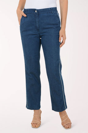 Person wearing blue jeans on a white background