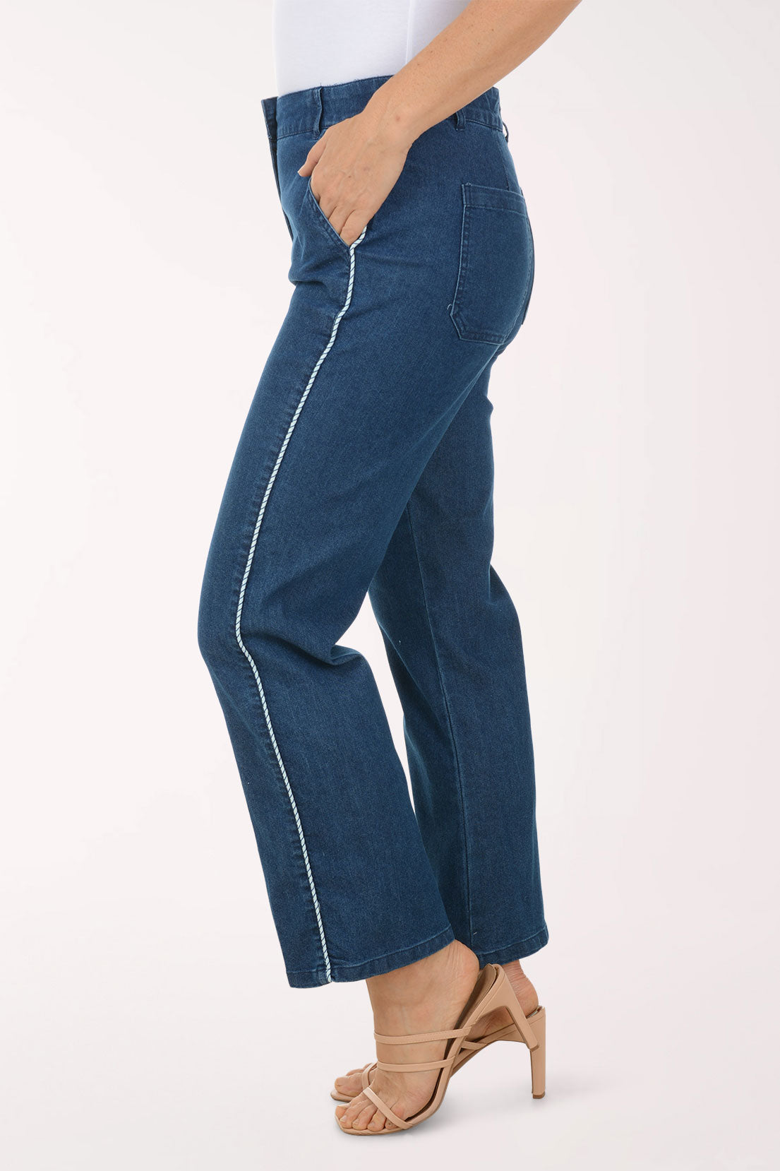 Person wearing blue jeans on a white background