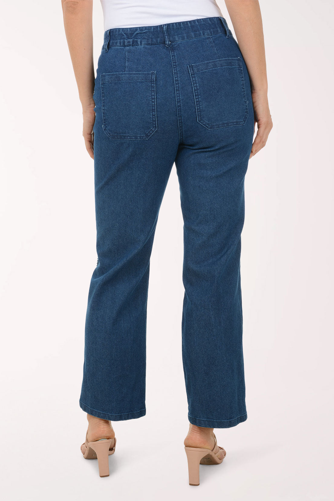 Person wearing blue jeans on a white background