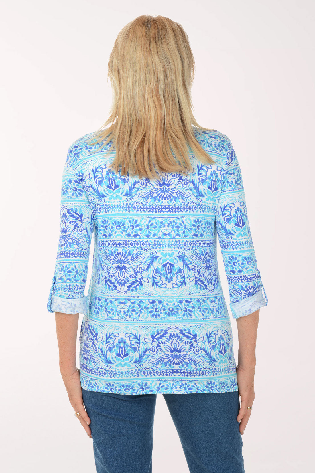 Woman wearing a blue patterned blouse on a white background