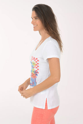 Woman wearing a white t-shirt with colorful graphic design on a white background